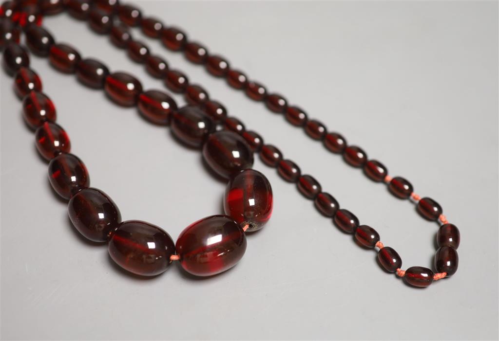 A single strand graduated oval simulated cherry amber bead necklace, 84cm, gross 90 grams.
